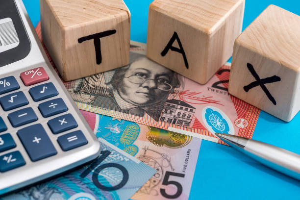 istock text tax with Australian dollar, pen and calculator 942154958