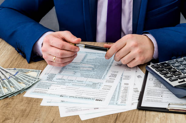 istock man fill tax form, account money 942155446