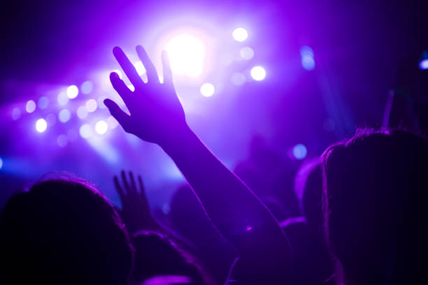 istock Cheering crowd at concert enjoying music performance 942155584