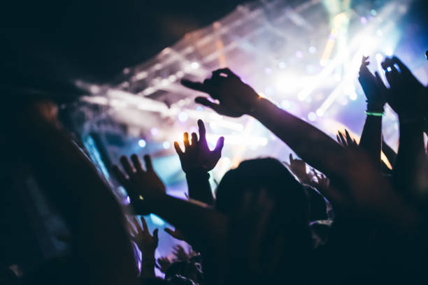 istock Cheering crowd at concert enjoying music performance 942155768