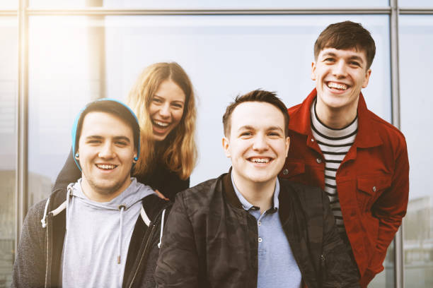 istock group of young friends having fun and laughing together 942155836