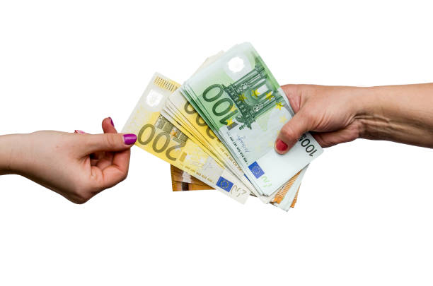 Female hand taking euro banknote from pile