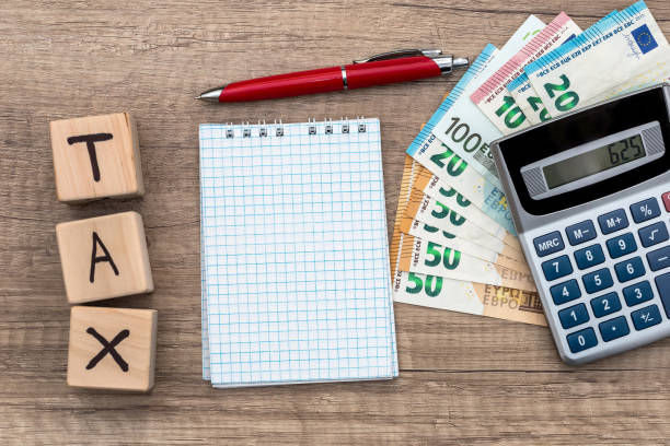 istock euro bills tax pen clock and blank notepad 942156888