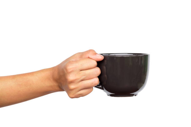 istock Close up of hand holding coffee cup. 942158386