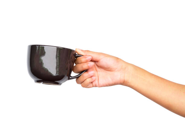 istock Close up of hand holding coffee cup. 942158432