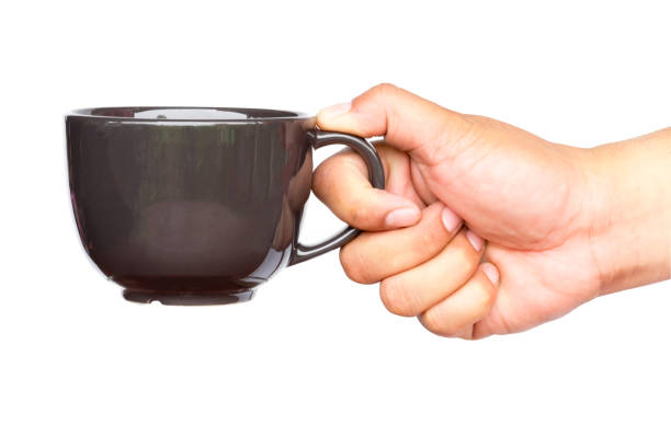istock Close up of hand holding coffee cup. 942158504