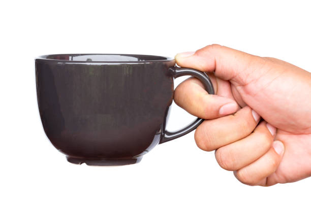 istock Close up of hand holding coffee cup. 942158554