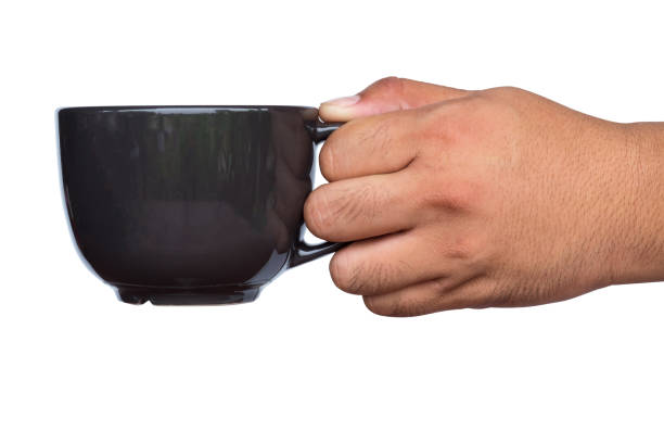 istock Close up of hand holding coffee cup. 942158556