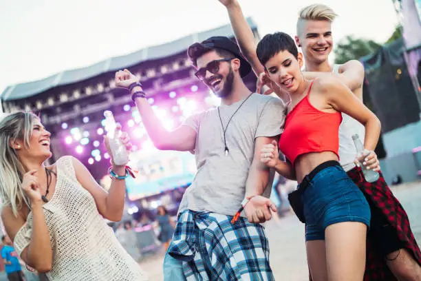 Photo of Group of friends having fun time at music festival