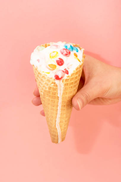 istock Hand holds ice cream that melts and drips in a waffle cone 942159160