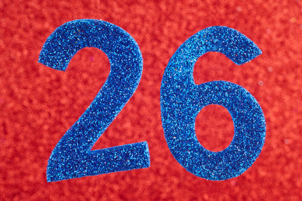 istock Number twenty-six blue color over a red background. Anniversary 942159644