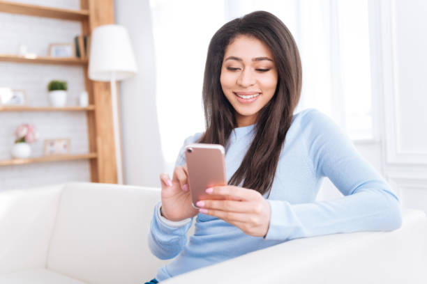 istock Pleasant jolly woman typing message 942160922