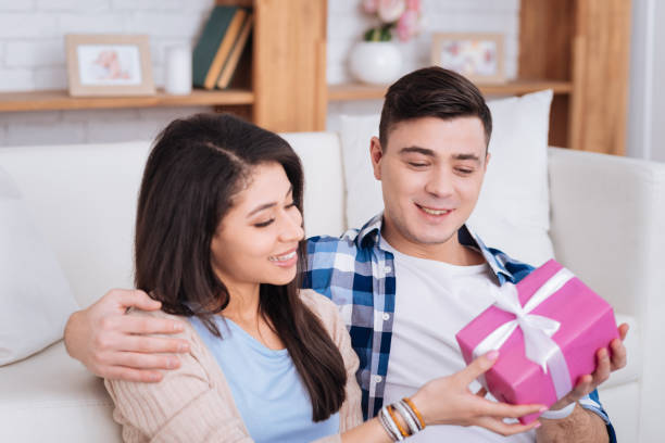 istock Happy man giving present to woman 942163992