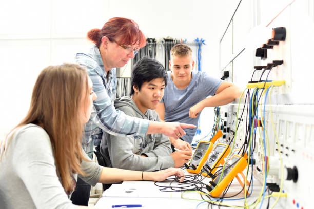 Group of young people in technical vocational training with teacher Group of young people in technical vocational training with teacher digital electronics stock pictures, royalty-free photos & images