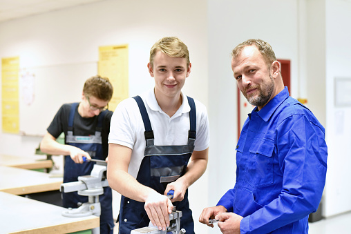 Group of young people in technical vocational training with teacher