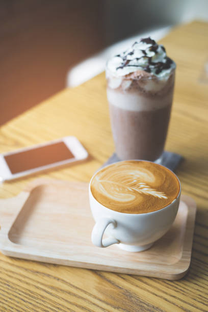 istock Mobile phone and coffee cup on office wooden table 942166072