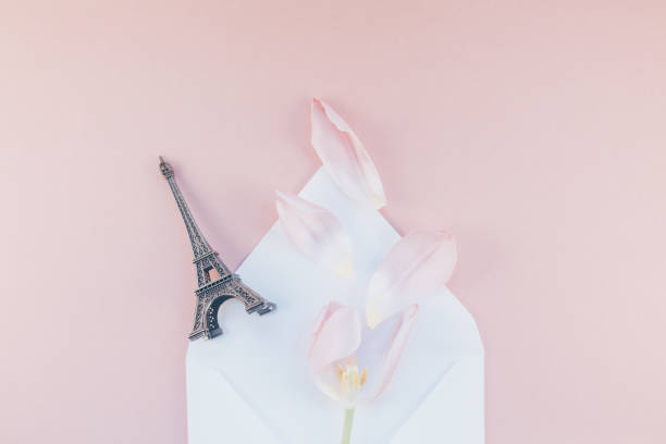 istock Pink tulip in envelope with eiffel tower miniature 942166262