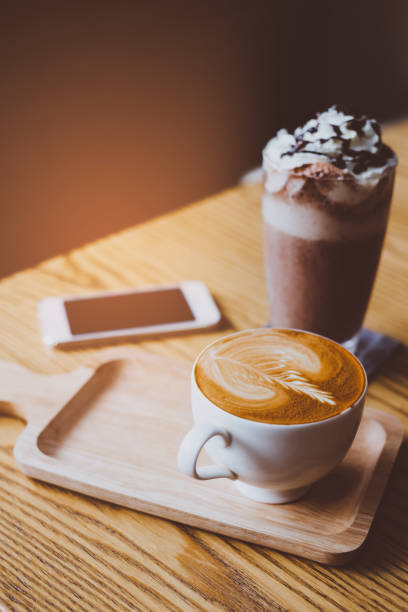 istock Mobile phone and coffee cup on office wooden table 942166578