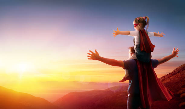 istock Daughter And Father Dressed As Heroes At Sunset 942169292
