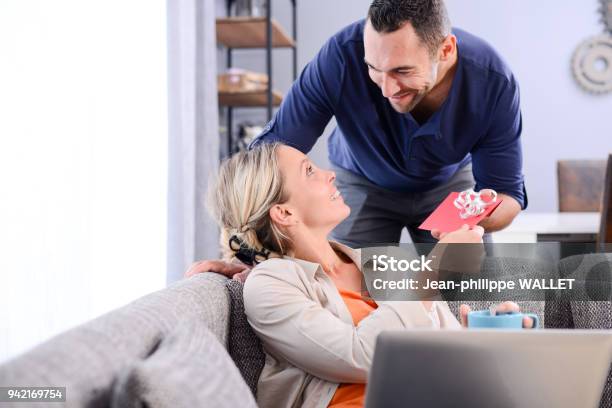 Handsome Man Offering Surprise Present Invitation In Envelope Gift To His Young Woman Valentine Girlfriend Stock Photo - Download Image Now