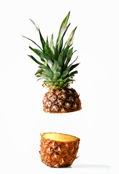 istock Fresh juicy pineaplle flying on white background 942170030