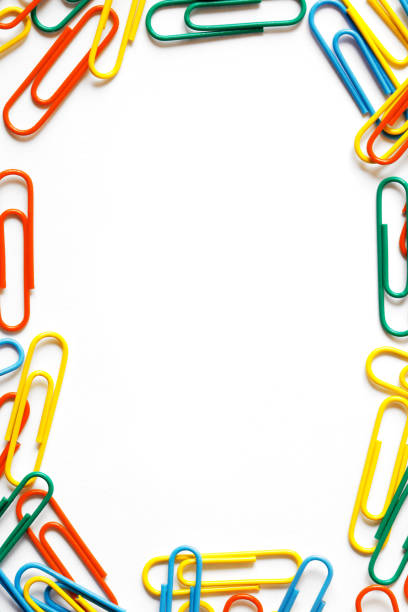 Frame made of multi colored paper clips isolated on a white background. Space for copy inside.