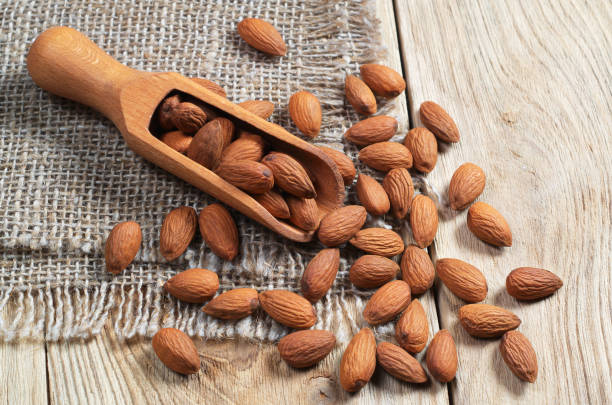 istock Almonds in wooden scoop 942171140