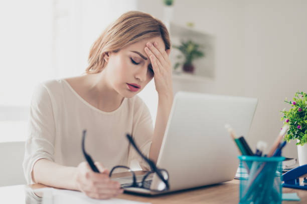 istock Overworked businesswoman suffering from headache and thinking how to end work 942171548