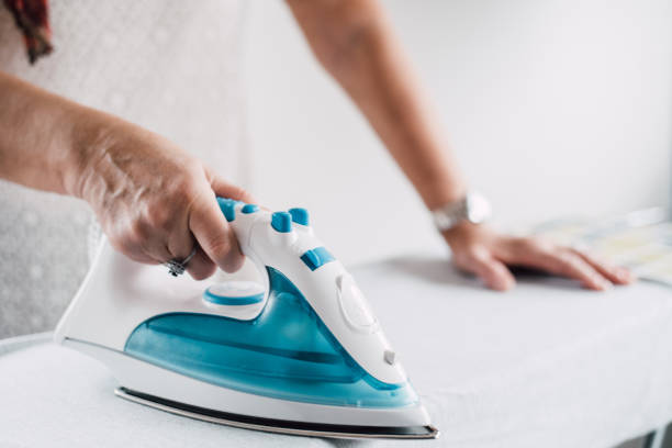 istock Senior woman ironing a shirt 942172228