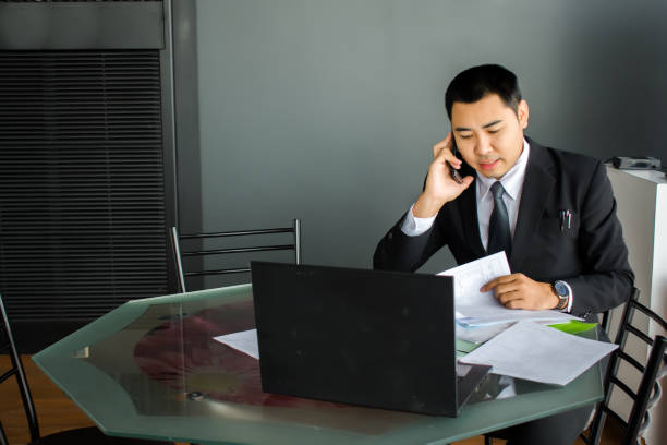 istock Asian man business are smiling and working computer in office on blurred background. For working or 