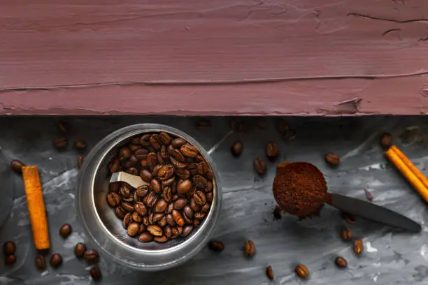 Coffee beans and ground by coffee near a wooden board. Copy space. Top view