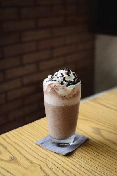 istock Ice cold coffee on a wooden table 942177120