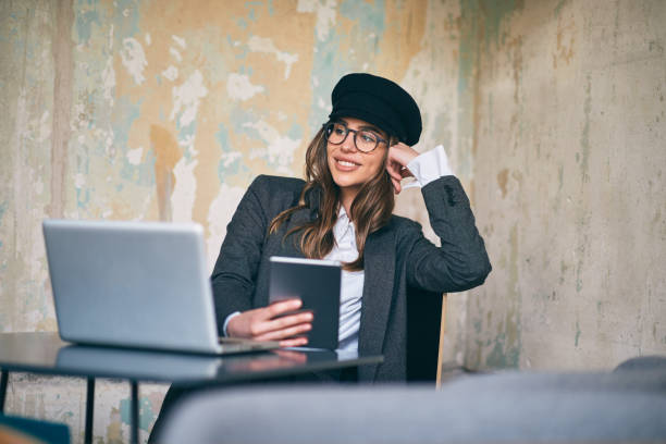 istock Woman sitting in cafe and working 942177258