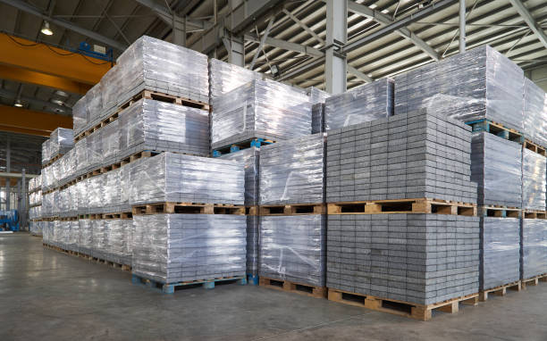 Paving slabs factory Paving slabs factory. Tiles piled in pallets. Warehouse paving slabs in the factory for its production construction material stock pictures, royalty-free photos & images