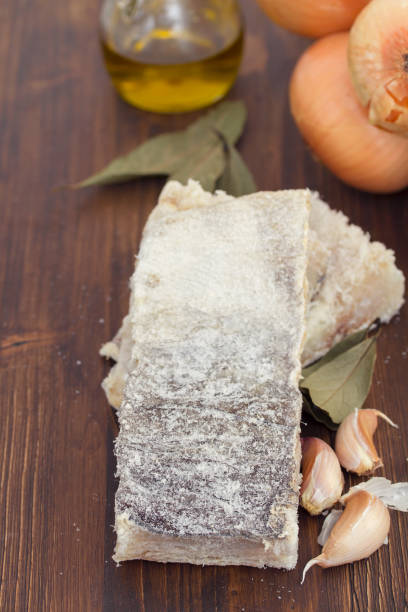 istock dry cod fish with onion on wooden background 942179418