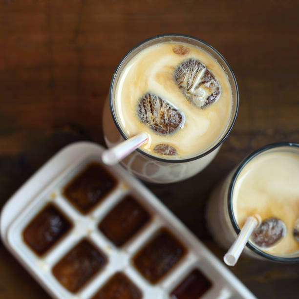 frozen coffee cubes with milk - cocktails on dark wooden table. Top view