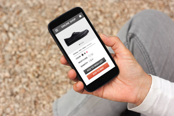 istock Hand holding smart phone with online shop concept on screen 942181674