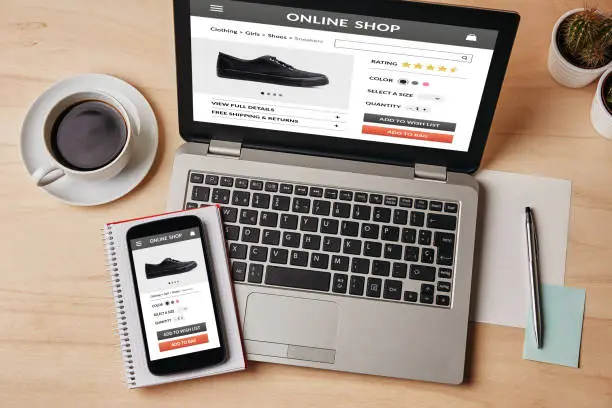 Photo of Online shop concept on laptop and smartphone screen