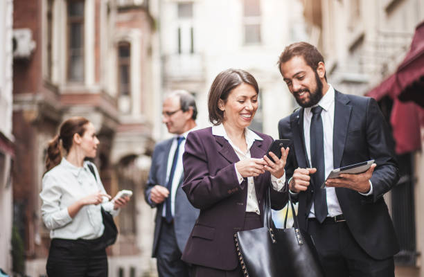 istock Business People Discussing, Walking Down The Street 942182696