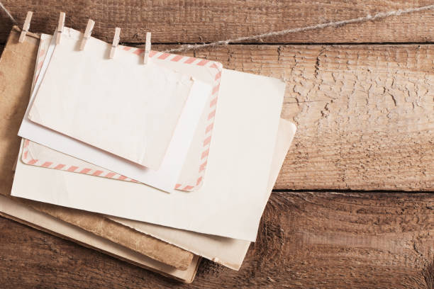 istock old paper on wooden background 942183642