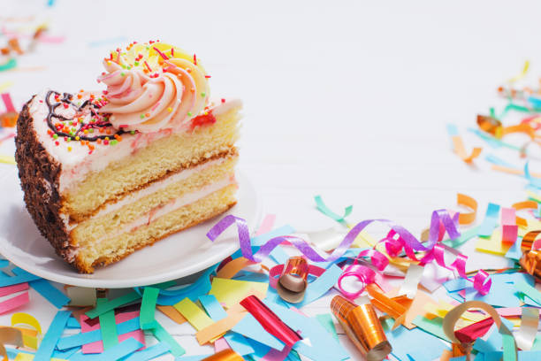 istock birthday cake and  decoration on white wooden background 942183698
