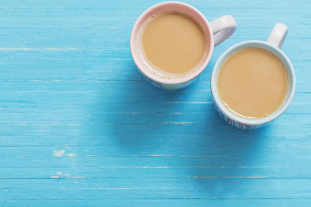 due tazze di caffè su sfondo blu in legno - morning coffee coffee cup two objects foto e immagini stock