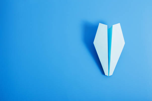 istock paper plane on blue color background 942183808