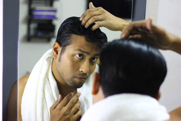 Indian Asian Man Looking After His Appearance In Front Of A Mirror Beauty  Styling Lifestylehair Styling Stock Photo - Download Image Now - iStock
