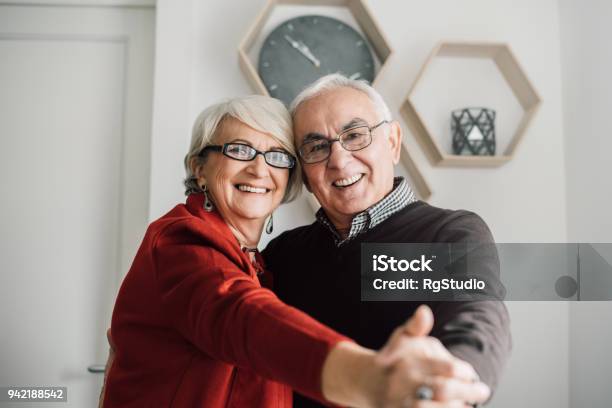 Older Couple In Love Dancing At Home Stock Photo - Download Image Now - Couple - Relationship, Teeth, Mature Adult