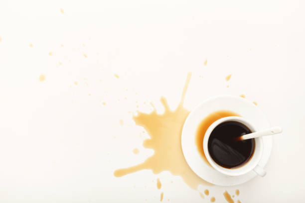 istock Coffee cup and spilt espresso on white background 942189204