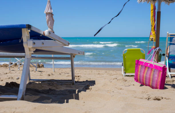 istock sunbed and sea bag on sandy beach with wind 942189278