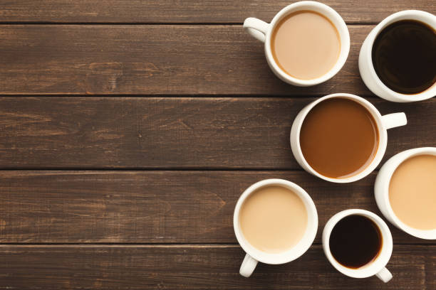 istock Different types of coffee in cups on wooden table, top view 942189356