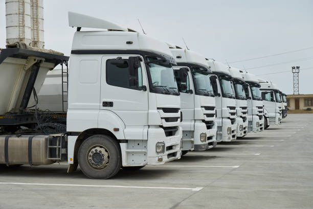 istock Big container trucks at warehouse building at factory. 942189844