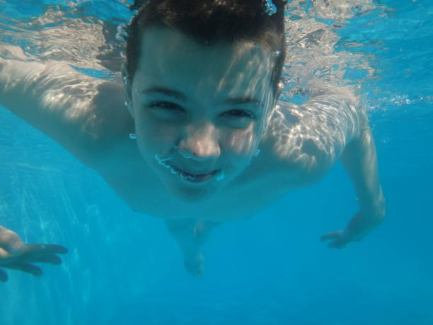 istock Underwater young boy fun in the swimming pool summer vacation fun 942190022